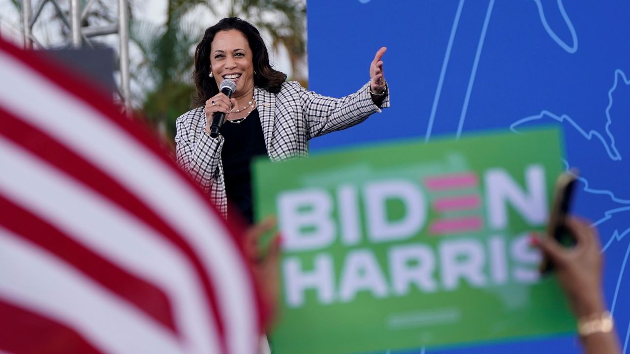 In this Oct. 31, 2020, file photo, Democratic vice presidential candidate Sen. Kamala Harris, D-Calif., speaks during a drive-in get out the vote rally at Palm Beach State College in Lake Worth, Fla. Harris made history Saturday, Nov. 7, as the first Black woman elected as vice president of the United States, shattering barriers that have kept men — almost all of them white — entrenched at the highest levels of American politics for more than two centuries. (AP Photo/Wilfredo Lee, File)