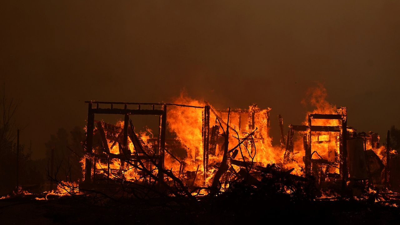 A home burns along Cima Mesa Rd. as the Bobcat Fire advances Friday, Sept. 18, 2020, in Juniper Hills, Calif. (AP Photo/Marcio Jose Sanchez)