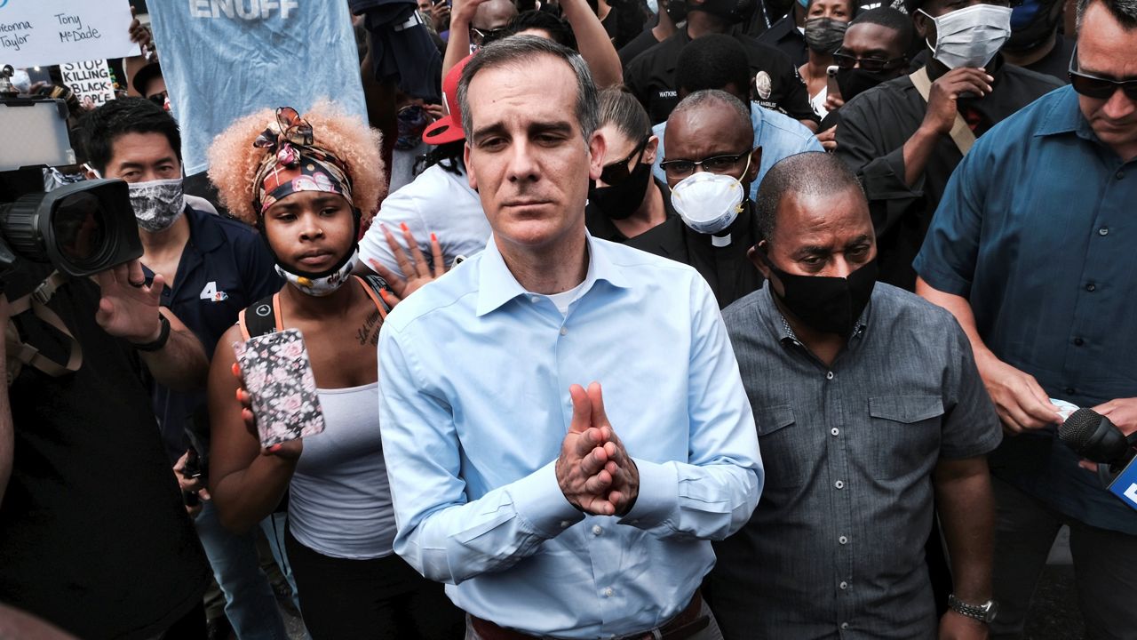 In this June 2, 2020, file photo, Los Angeles Mayor Eric Garcetti arrives to appeal to Black Lives Matter protesters in downtown Los Angeles. (AP/Richard Vogel)