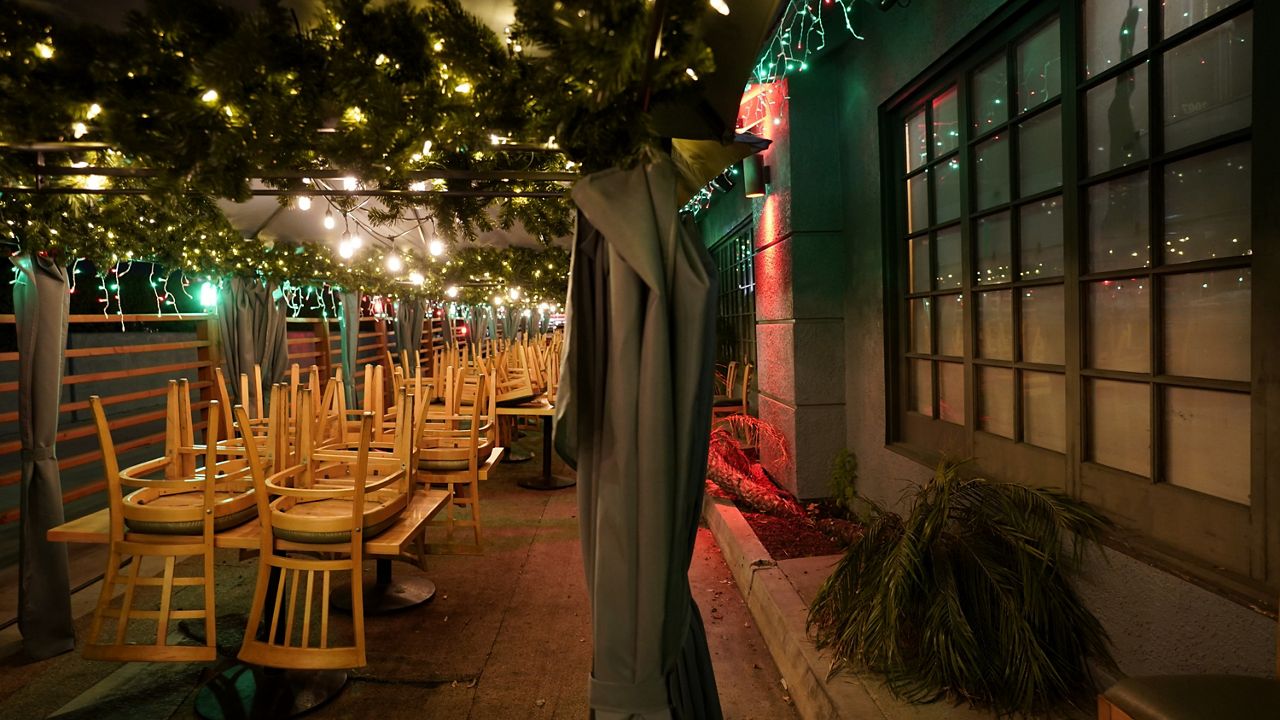 Chairs are stacked on tables in the closed outdoor dining area of a restaurant in Rowland Heights. Outdoor dining was closed throughout Los Angeles County following a public health order on Nov. 25. (AP Photo/Jae C. Hong, File)
