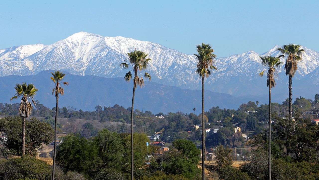 This Jan. 12, 2016 file photo shows the snow-capped San Gabriel Mountains, with Mount Baldy the highest peak at the left, seen from Chinatown near downtown Los Angeles.(AP Photo/Nick Ut, File)