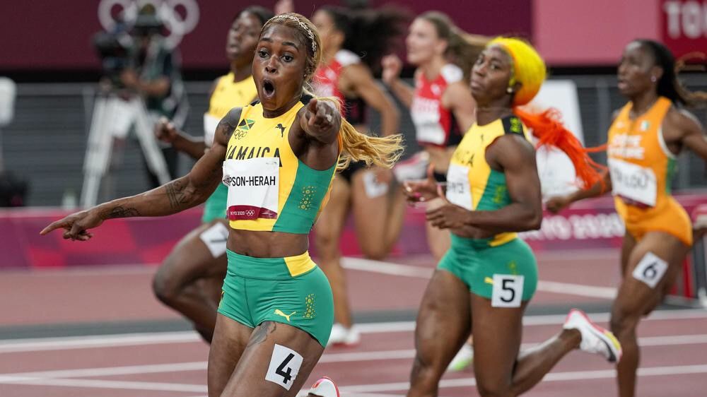 Elaine Thompson-Herah of Jamaica celebrates as she wins the women's 100-meters final at the 2020 Summer Olympics in Tokyo. (AP/David J. Phillip)