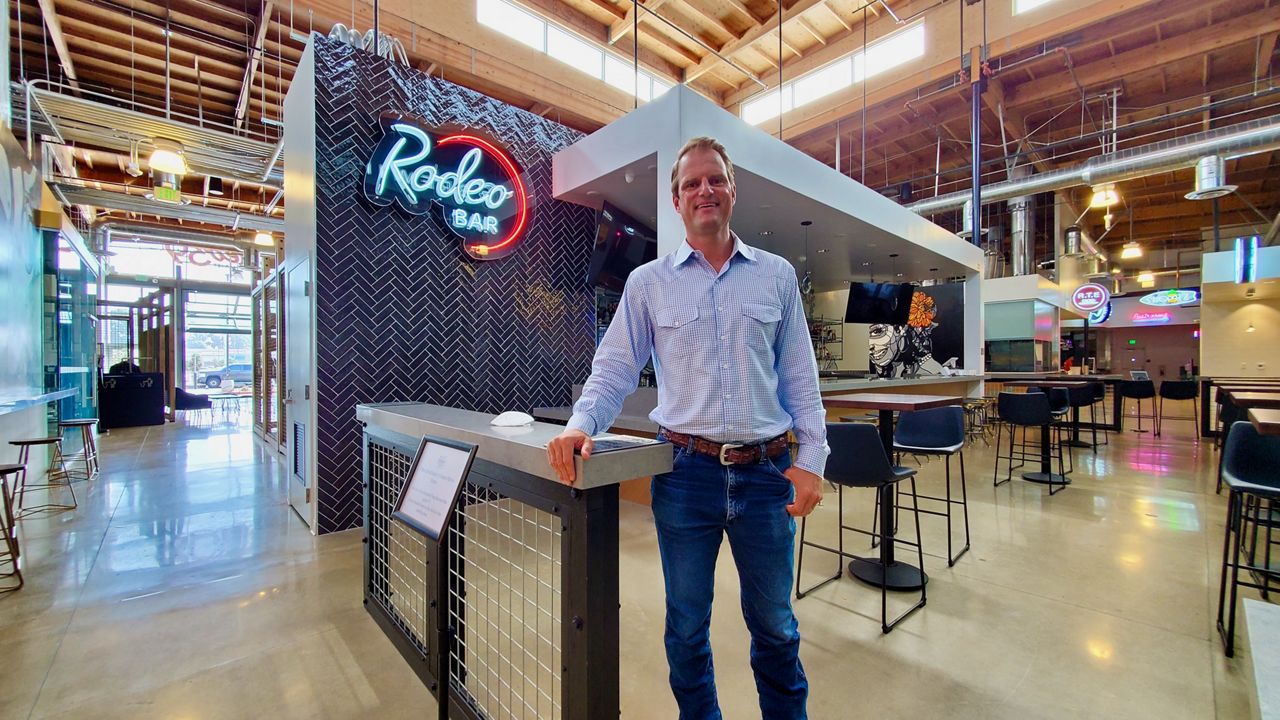 Frontier Real Estate Investments Managing Partner Dan Almquist stands in front of the Rodeo Bar inside the Rodeo 39 food hall in Stanton.