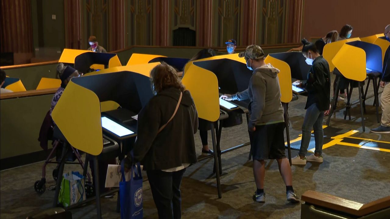 Southern California residents wearing masks cast their votes at The Wiltern in Los Angeles on Saturday, October 24, 2020.