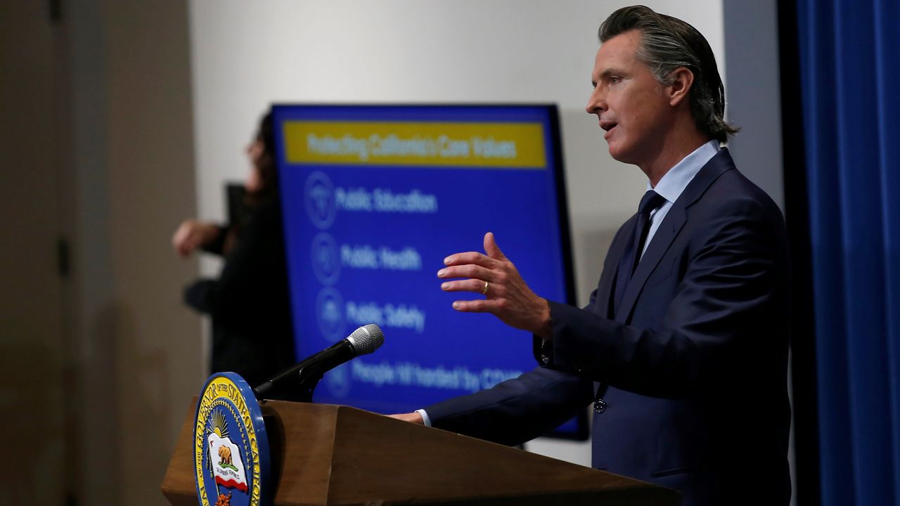 -In this May 14, 2020 file photo Gov. Gavin Newsom discusses his revised 2020-2021 state budget during a news conference in Sacramento, Calif. Newsom will unveil his 2021-2022 proposed state budget Friday, Jan. 8. (AP Photo/Rich Pedroncelli, File, Pool)