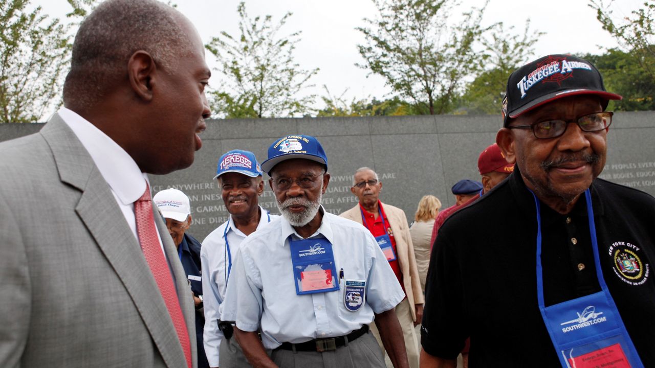 In this Aug. 3, 2011, file photo, Harry E. Johnson Sr., left, president & CEO of the Martin Luther King Jr. Foundation, takes Tuskegee Airmen, including Theodore Lumpkin Jr., center, and Dabney Montgomery, right, on a tour of the Martin Luther King Jr. Memorial in Washington. Lumpkin has died from complications of the coronavirus, it was announced Friday. Lumpkin was just days short of his 101st birthday. Lumpkin, a Los Angeles native, died Dec. 26, according to a statement from Los Angeles City College, which he attended from 1938 to 1940. (AP Photo/Jacquelyn Martin, File)