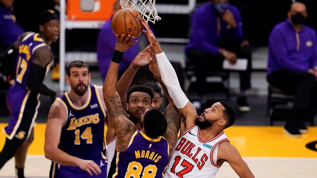 Chicago Bulls center Wendell Carter Jr. , center, and guard Garrett Temple (17) defend against Los Angeles Lakers forward Markieff Morris (88) during the third quarter of an NBA basketball game Friday, Jan. 8, 2021, in Los Angeles. (AP Photo/Ashley Landis)