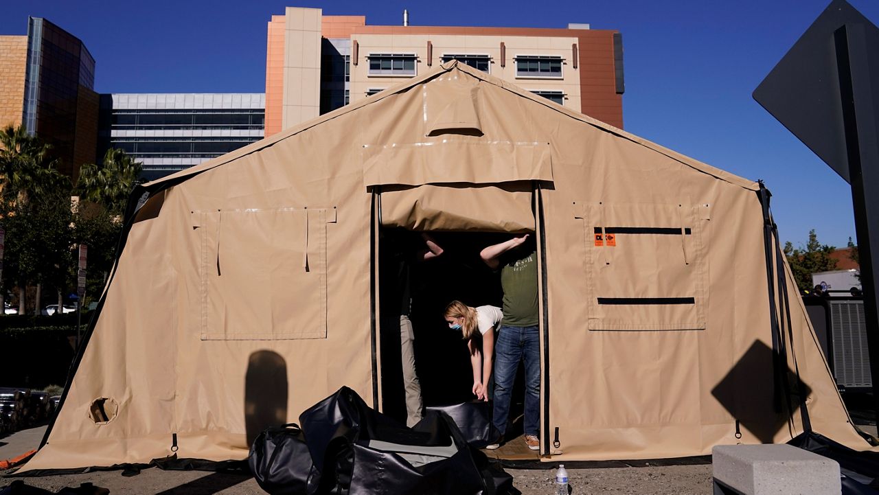 Volunteers help set up a mobile field hospital at UCI Medical Center in Orange on Dec. 21, 2020. (AP Photo/Jae C. Hong)