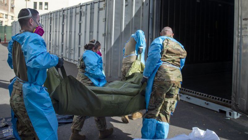  This Jan. 12, 2021, file photo provided by the L.A. County Dept. of Medical Examiner-Coroner shows National Guard members assisting with processing COVID-19 deaths and placing them into temporary storage at L.A. County Medical Examiner-Coroner Office in Los Angeles. (LA County Dept. of Medical Examiner-Coroner via AP, File)