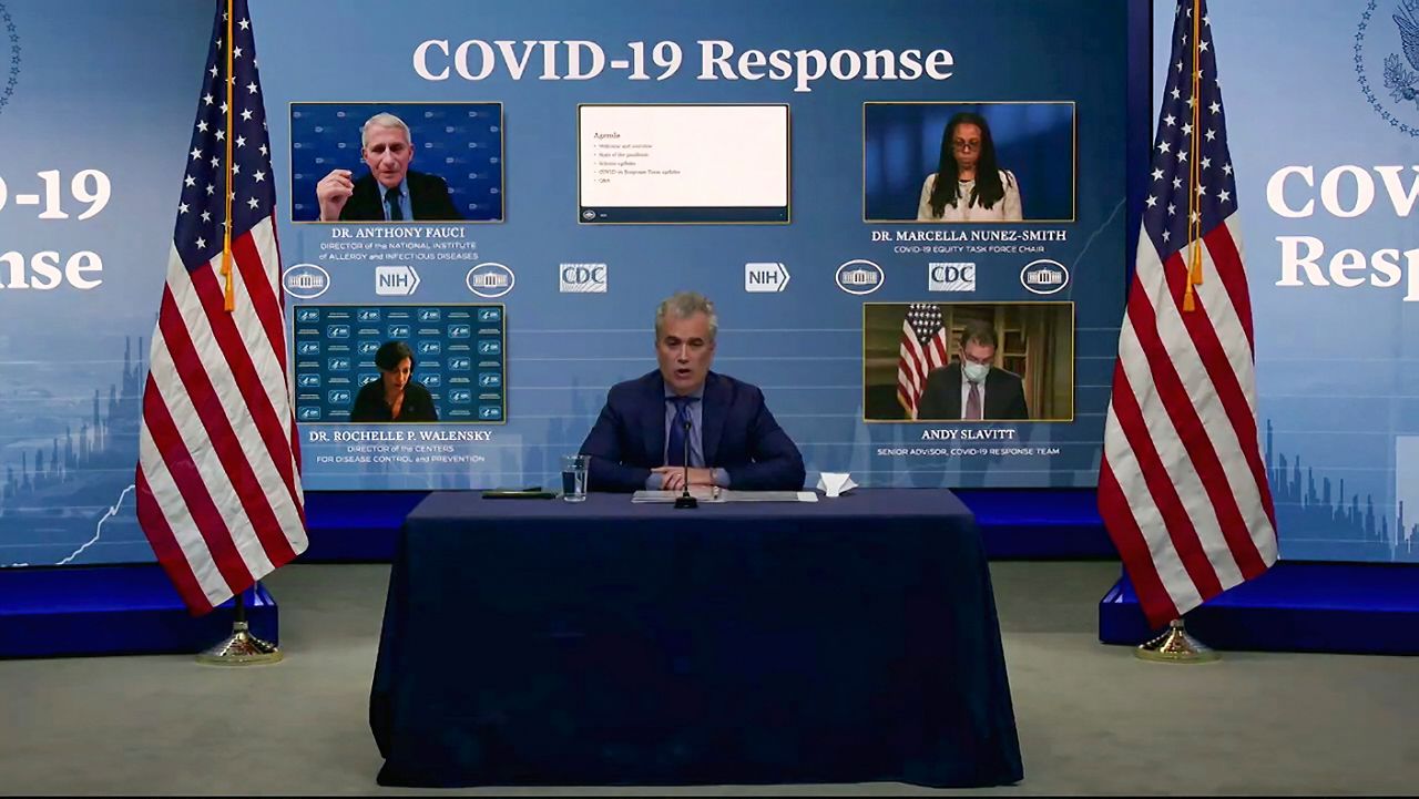 Jeff Zients, White House coronavirus response coordinator, speaks as Dr. Anthony Fauci, Dr. Marcella Nunez-Smith, chair of the COVID-19 health equity task force, Dr. Rochelle Walensky, director of the CDC, and Andy Slavitt, senior adviser to the White House COVID-19 Response Team,, appear on screen during a White House briefing, Jan. 27, 2021, in Washington. (White House via AP)