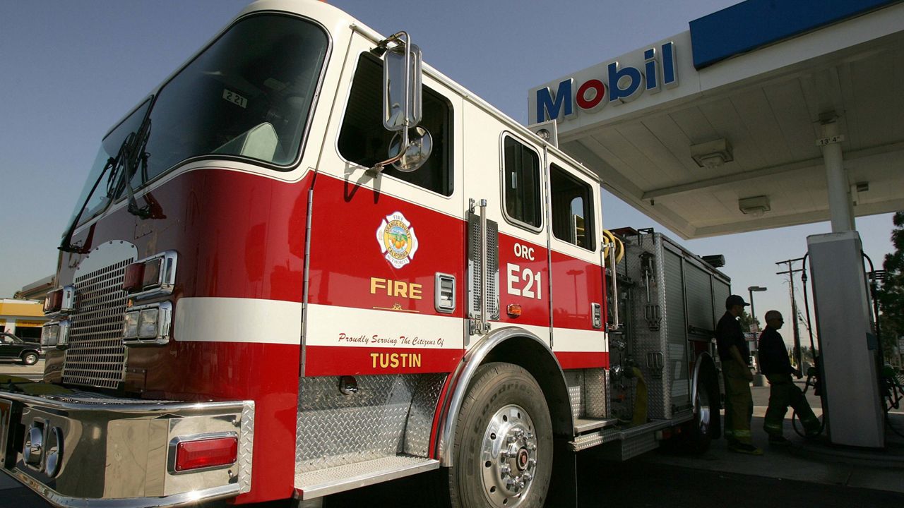 In this file photo from Aug. 26, 2005, firefighter David Backoff, left, and Engineer Ray Johnson fill Orange County Fire Engine 21 at a Mobil station in Tustin. (AP Photo/Chris Carlson)