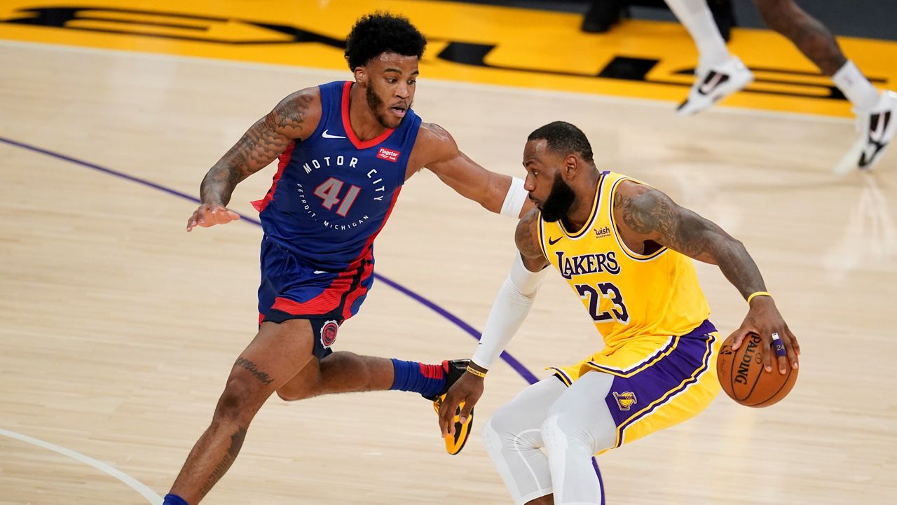 Los Angeles Lakers forward LeBron James (23) is defended by Detroit Pistons forward Saddiq Bey (41) during the first half of an NBA basketball game Saturday, Feb. 6, 2021, in Los Angeles. (AP Photo/Marcio Jose Sanchez)