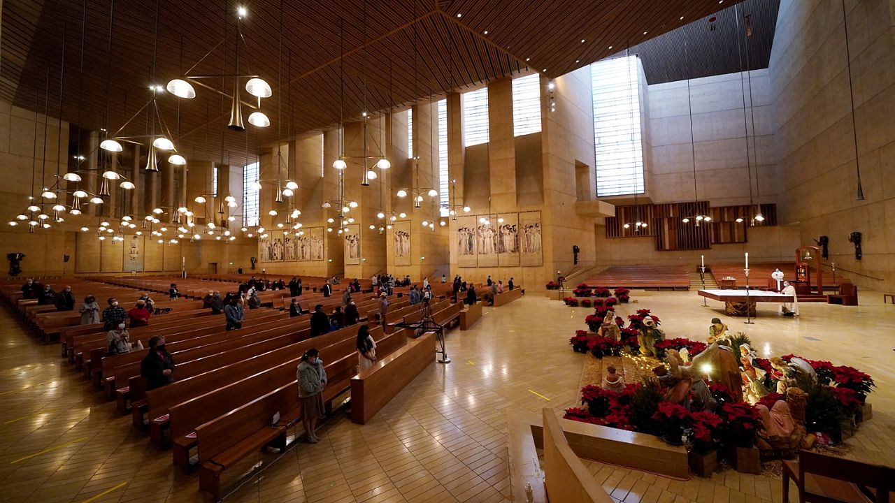 In this Dec 24, 2020, file photo, worshippers gather for Christmas Eve Mass at the Cathedral of Our Lady of the Angels in Los Angeles. (AP Photo/Ashley Landis)