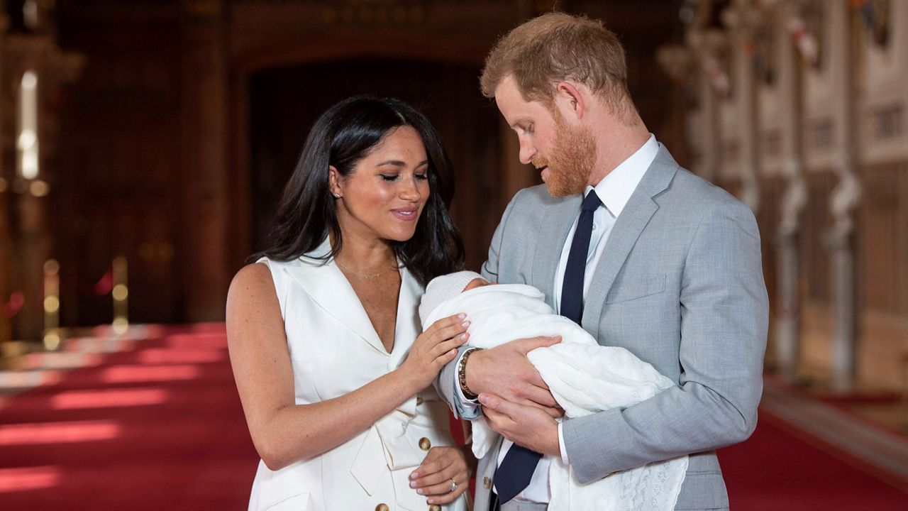 In this May 8, 2019 file photo, Britain's Prince Harry and Meghan, Duchess of Sussex, pose with their newborn son Archie, in St George's Hall at Windsor Castle, Windsor, south England. (Dominic Lipinski/Pool via AP)