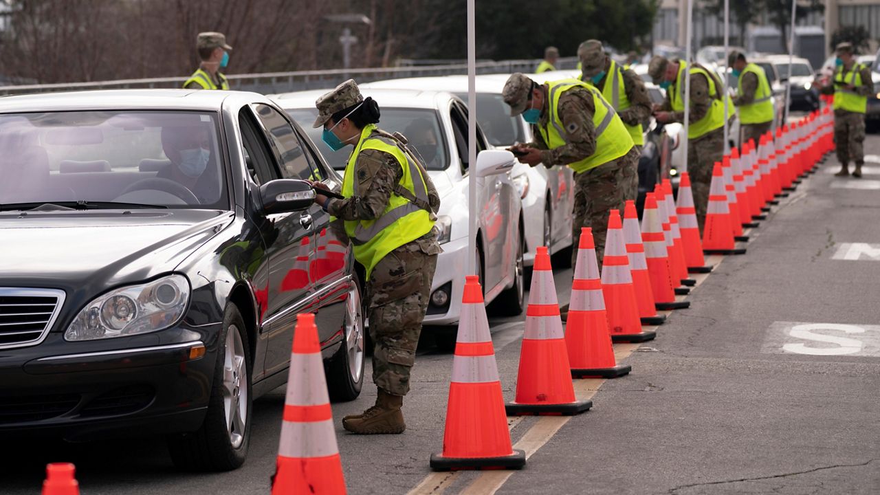 Members of the National Guard check in motorists Tuesday at a federally-run COVID-19 vaccination site set up at California State University, Los Angeles in Los Angeles. (AP Photo/Jae C. Hong)