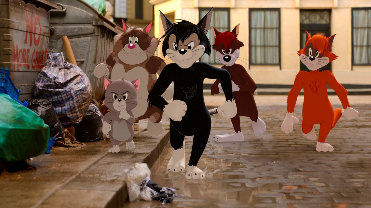 This image shows Butch, leader of the alley cats, foreground center, voiced by Nicky Jam, in a scene from the animated/live-action film "Tom & Jerry." (Warner Bros. Pictures via AP)