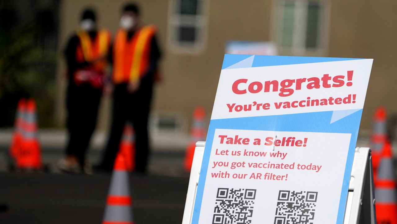 A selfie station congratulates people for getting vaccinated with the Moderna COVID-19 vaccine at a site for Los Angeles School District employees in the parking lot of SOFI Stadium in Inglewood on March 2, 2021. (AP Photo/Marcio Jose Sanchez)