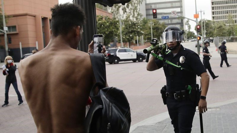  In this June 2, 2020, file photo, a police officer aims his less-lethal weapon at a demonstrator during a protest in Los Angeles.  (AP Photo/Jae C. Hong, File)