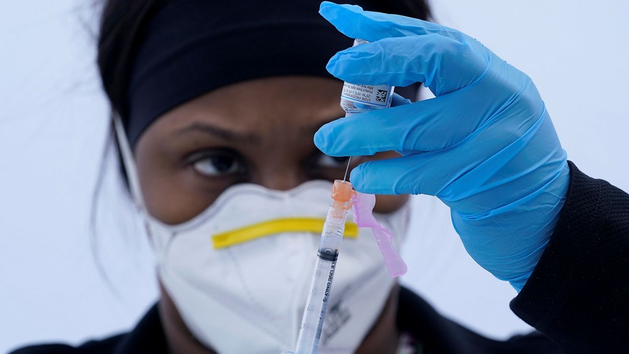 In this March 3, 2021, file photo, licensed vocational nurse Jelisa Stewart prepares a dose of the Moderna COVID-19 vaccine. (AP Photo/Jeff Chiu, File)