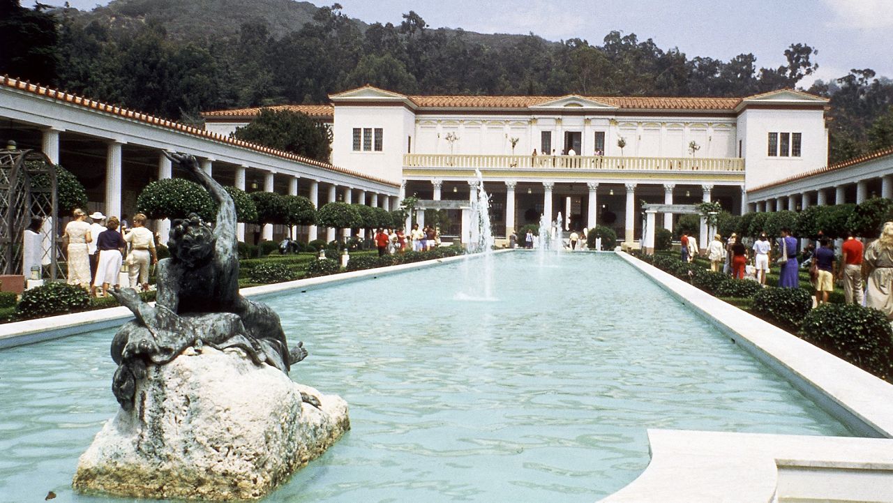 Visitors walk beside a pool in the Jean Paul Getty Museum in Malibu in 1984. On either side are Greek and Roman antiquities, the main concern in this part of the 2-floor establishment. (AP Photo/Emily Lane)