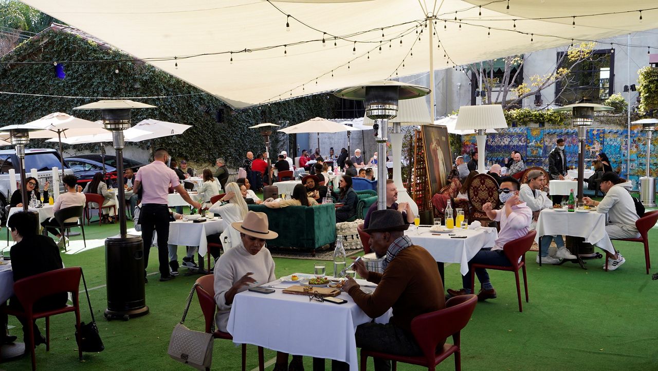 People dine under a tent outside a restaurant on Valentine's Day in West Hollywood. (AP Photo/Damian Dovarganes)