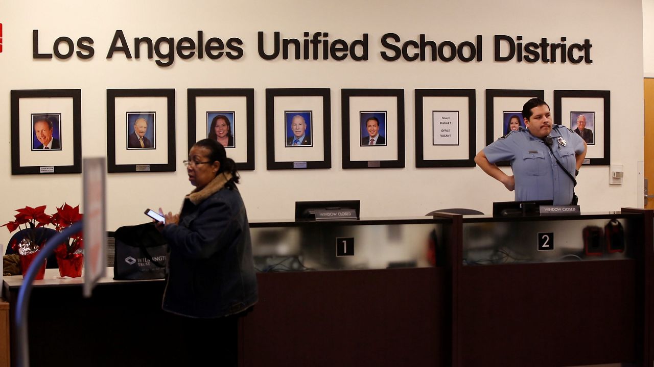 This Jan. 11, 2019, file photo, shows Los Angeles Unified School District Superintendent Austin Beutner, pictured far left, along with other LAUSD Board members at their headquarters lobby in Los Angeles. (AP Photo/Damian Dovarganes)