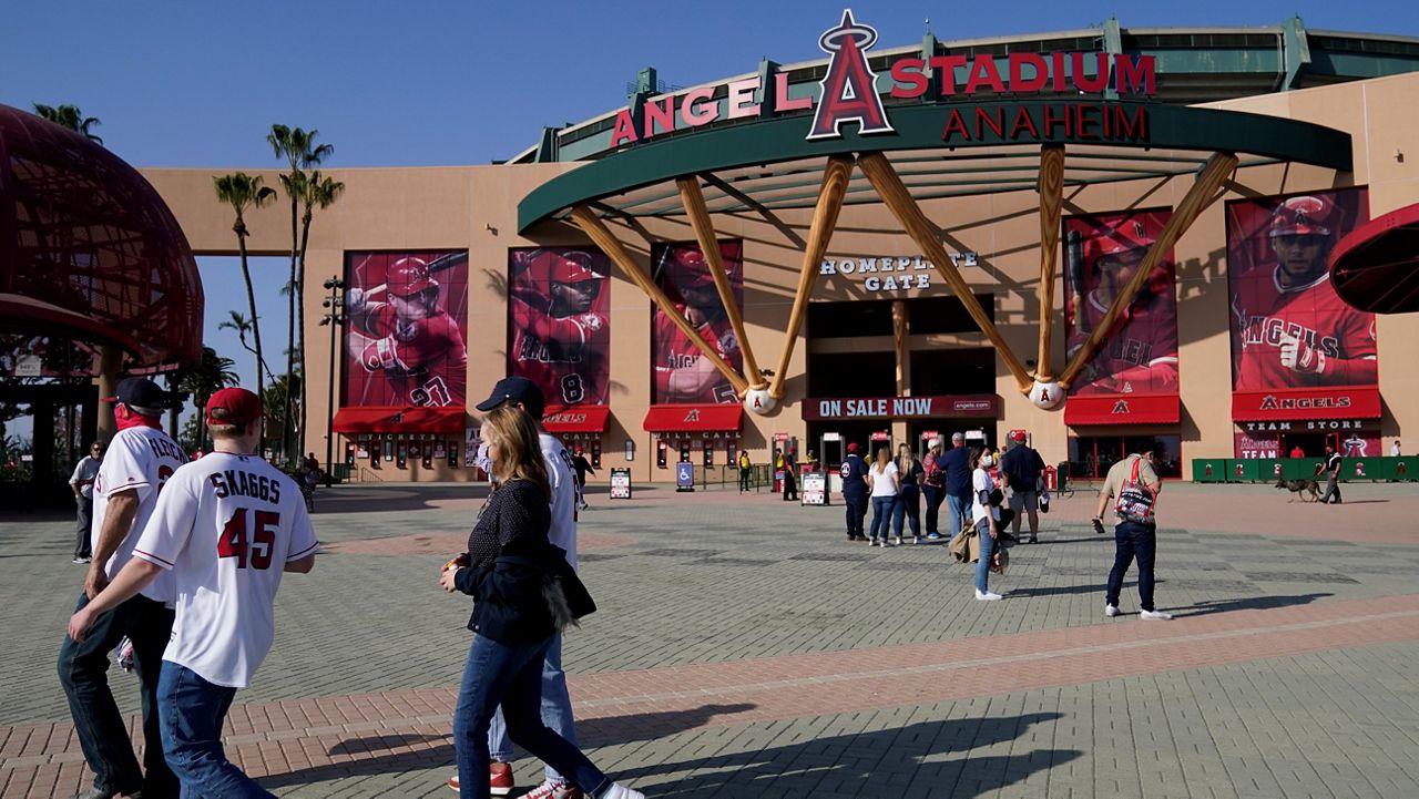  In this April 17, 2021, file photo, fans walk outside Angel Stadium when a baseball game between the Minnesota Twins and the Los Angeles Angels was postponed in Anaheim. (AP Photo/Ashley Landis)