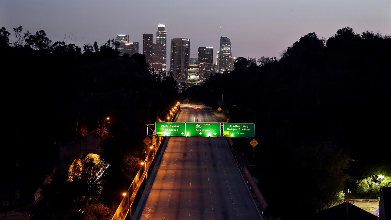 In this April 2, 2020, file photo, light traffic is seen on the 110 freeway with the city skyline in the background in Los Angeles. For decades a symbol of boundless growth and opportunity that attracted people from across the U.S. and abroad, California has stagnated. (AP Photo/Marcio Jose Sanchez, File)