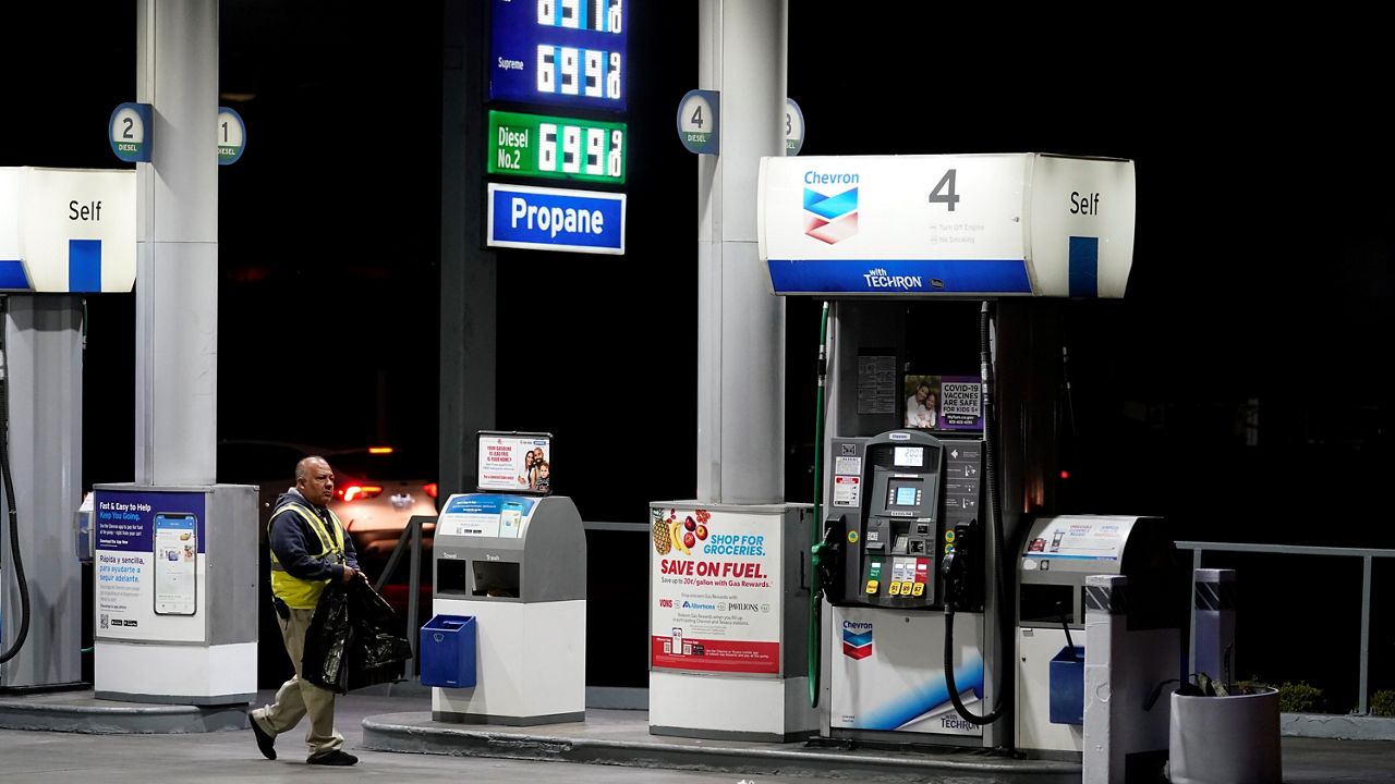 An attendant walks past a pump at a station selling gas at over $6 a gallon on March 7, 2022, in Los Angeles. (AP Photo/Marcio Jose Sanchez)