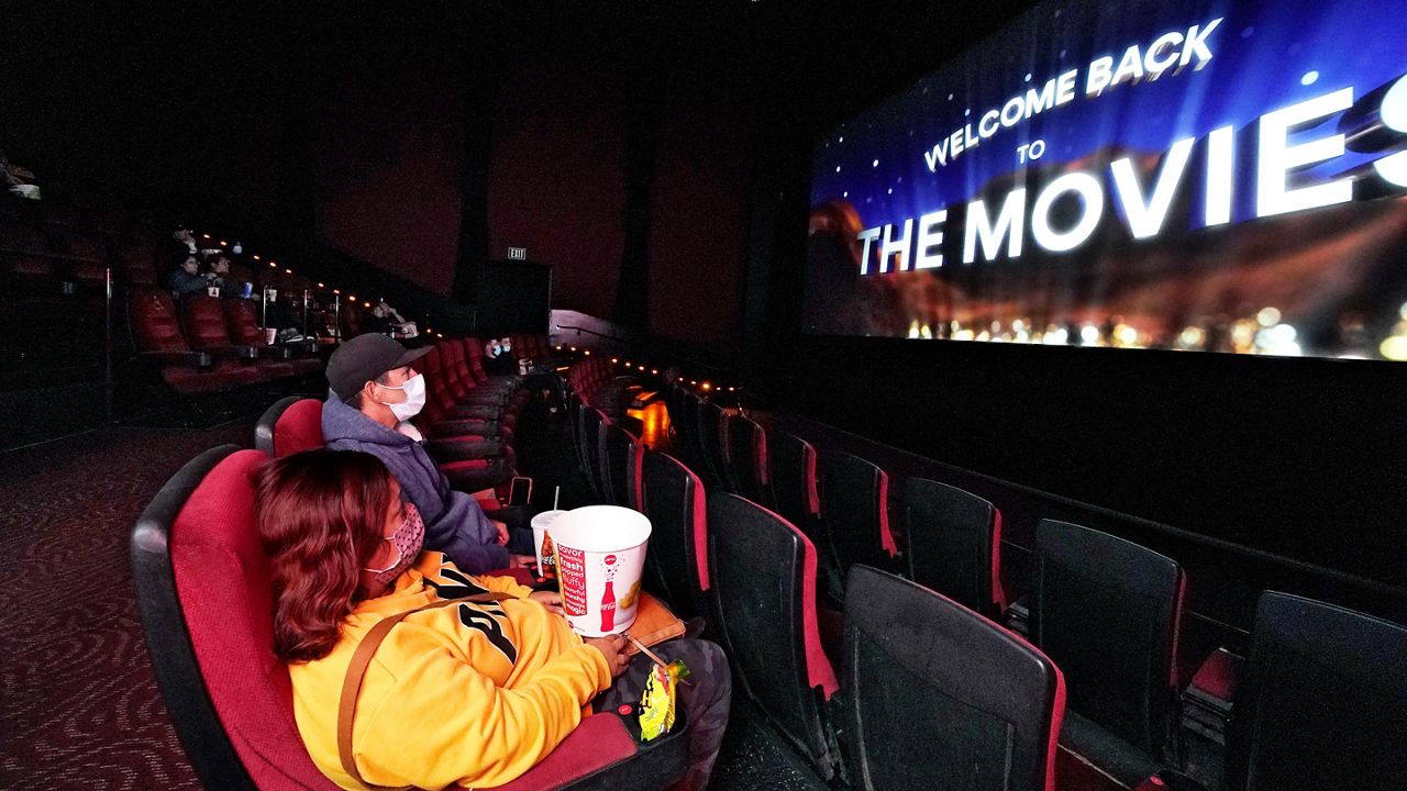 In this March 15, 2021, file photo, moviegoers wait for a film to start at the AMC 16 theater in Burbank, Calif. (AP Photo/Mark J. Terrill)