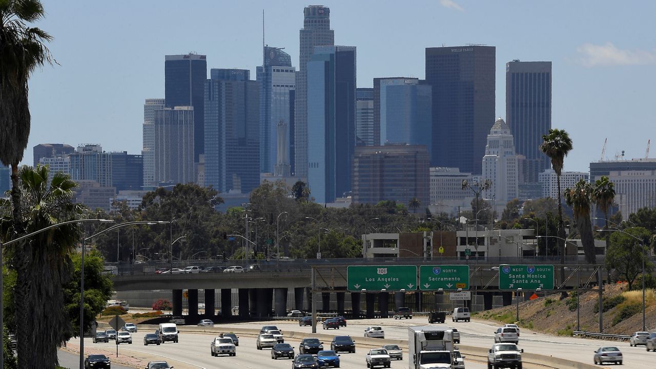 In this May 19, 2020, file photo traffic moves along Interstate 10 as downtown Los Angeles is seen in the background. (AP Photo/Mark J. Terrill)