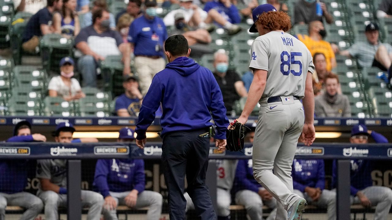 Los Angeles Dodgers starting pitcher Dustin May leaves the game after being injured during the second inning of a baseball game Saturday against the Milwaukee Brewers in Milwaukee. (AP Photo/Morry Gash)