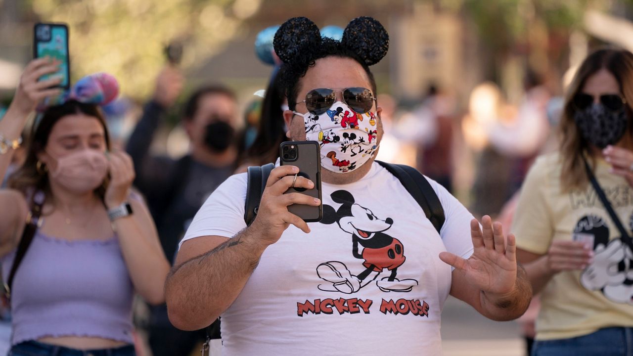 In this April 30, 2021, file photo, guests walk along Main Street USA at Disneyland in Anaheim. (AP Photo/Jae C. Hong, File)