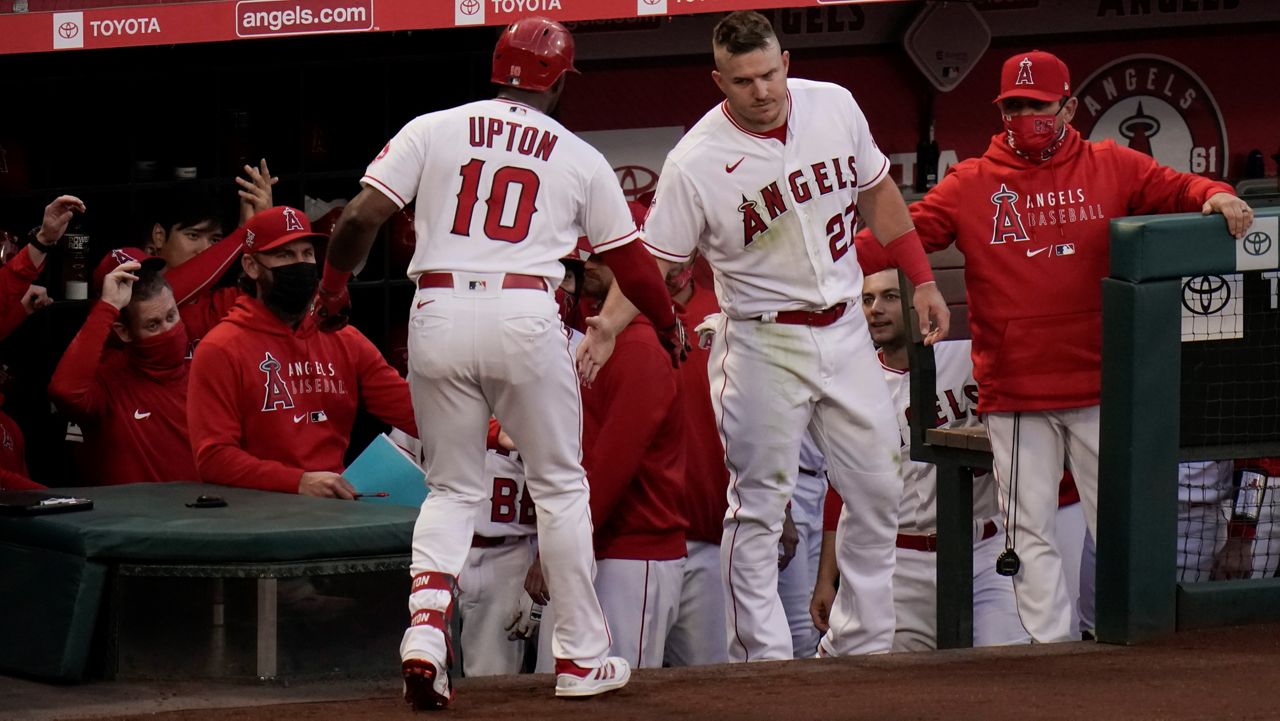 Los Angeles Angels' Justin Upton, left, is congratulated by Mike Trout after hitting a home run during the second inning of a baseball game Friday against the Los Angeles Dodgers in Anaheim, Calif. (AP Photo/Jae C. Hong)