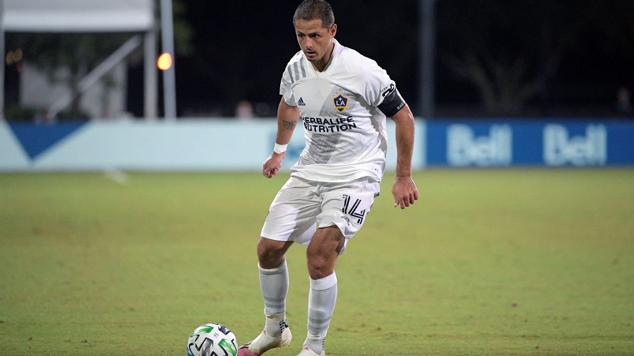 LA Galaxy forward Chicharito (14) controls the ball during the second half of an MLS soccer match against the Portland Timbers, Monday, July 13, 2020, in Kissimmee, Fla. (AP Photo/Phelan M. Ebenhack)