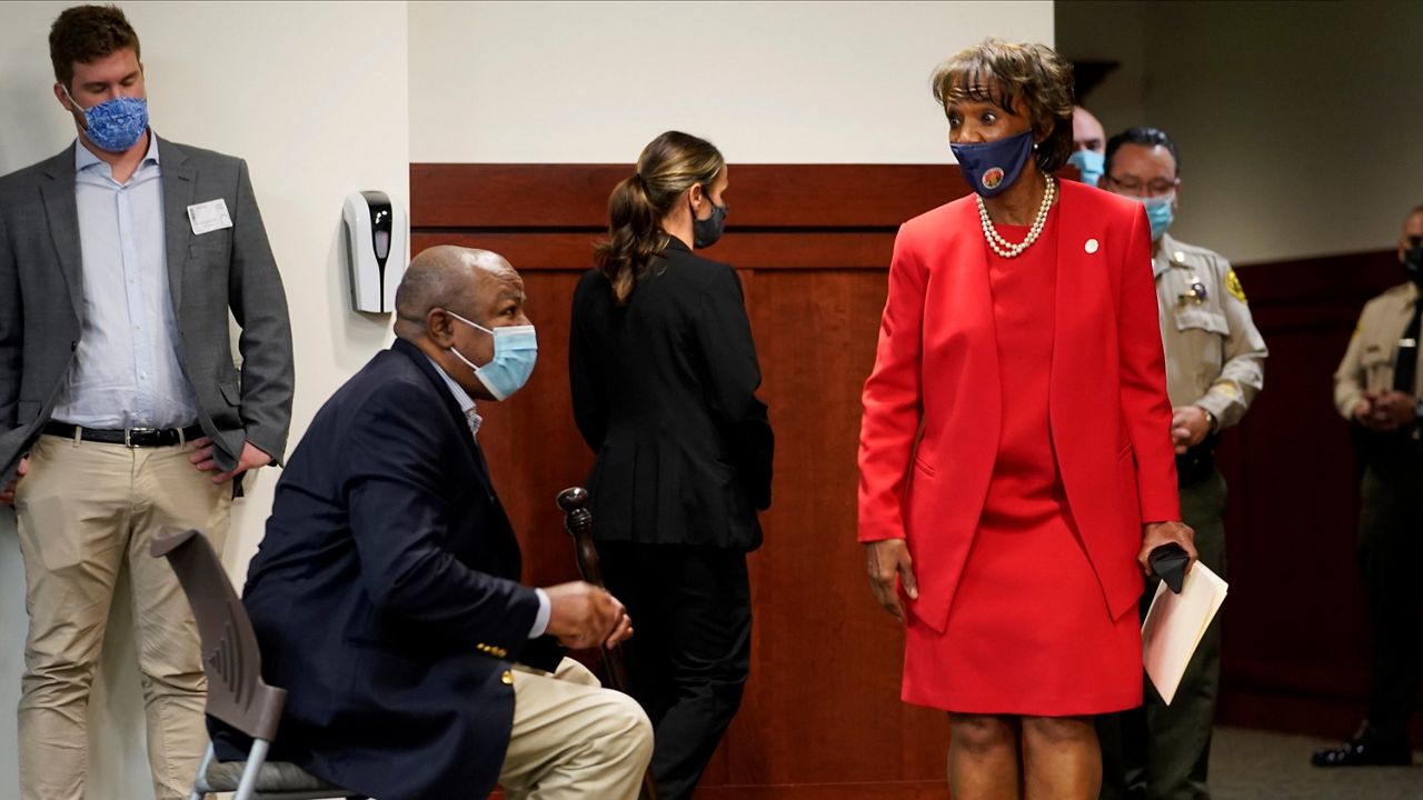 In this Nov. 6, 2020, file photo, Los Angeles District Attorney Jackie Lacey, right, with her husband David Lacey, sitting left, arrive at a news conference at the Hall of Justice in Los Angeles. Lacey conceded to former San Francisco District Attorney George Gascon during a news conference. (AP Photo/Damian Dovarganes)