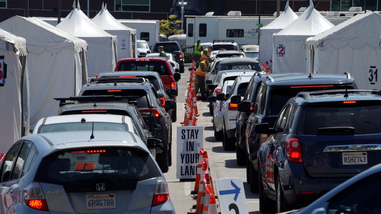 In this April 8, 2021, file photo, motorists sit inside their vehicles as they wait their turn to be inoculated with a COVID-19 vaccine at the California State University, Los Angeles campus in Los Angeles. (AP Photo/Damian Dovarganes)