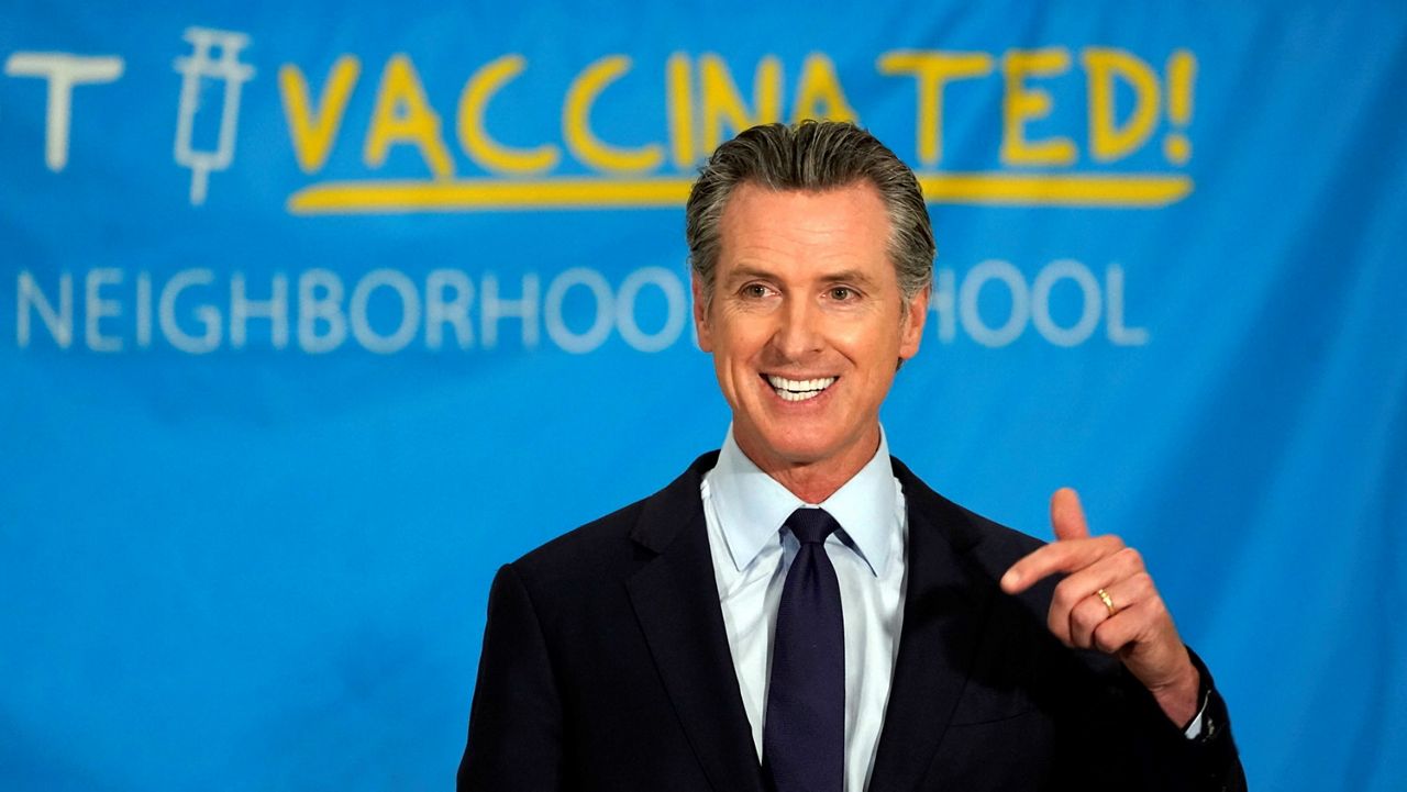 In this May 27, 2021, file photo, California Gov. Gavin Newsom announces a massive jackpot as the state looks to encourage millions of people who are still unvaccinated to get their shots at a news conference at the Esteban E. Torres High School in Los Angeles. (AP Photo/Damian Dovarganes)