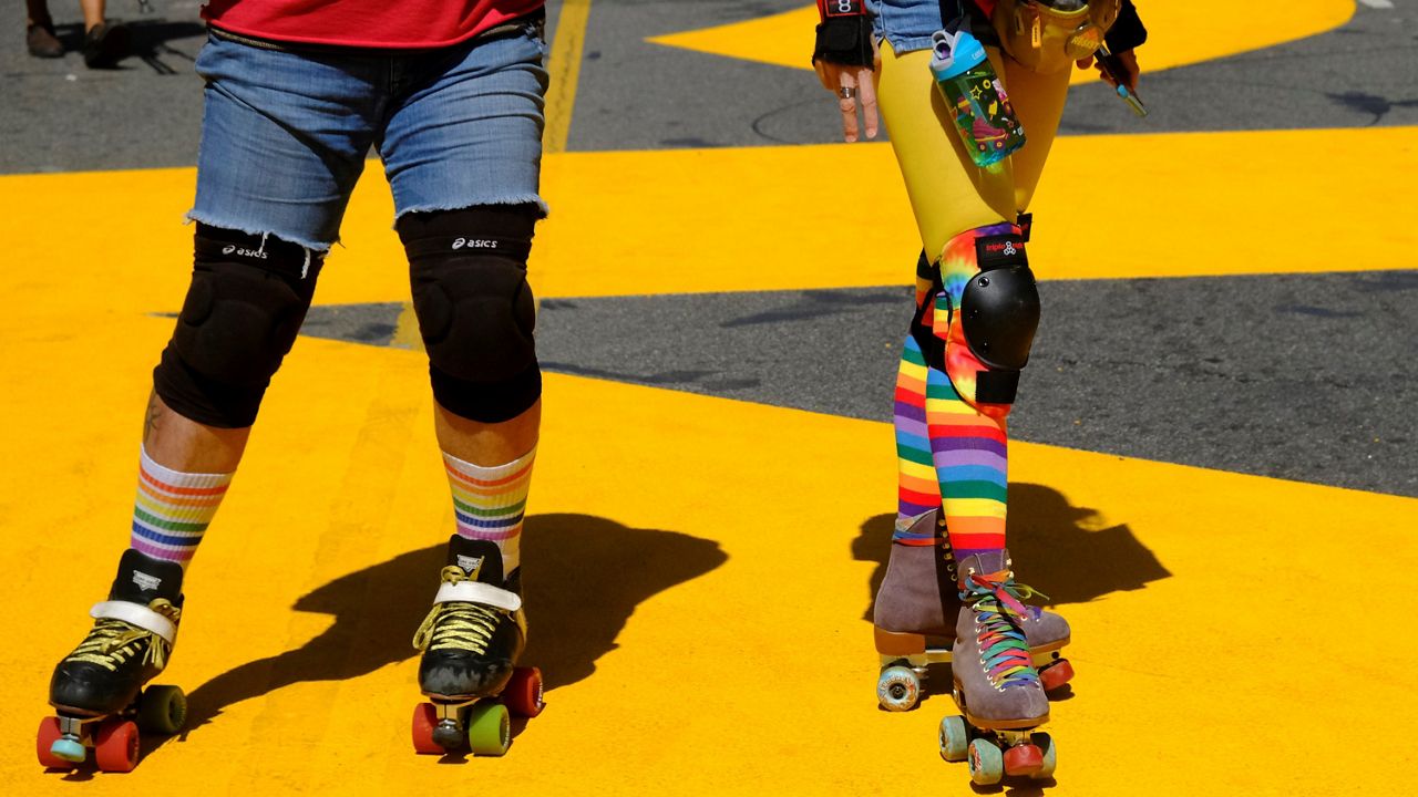 Protesters on roller skates attend the All Black Lives Matter march, organized by black LGBTQ+ leaders on June 14, 2020. (AP Photo/Paula Munoz)