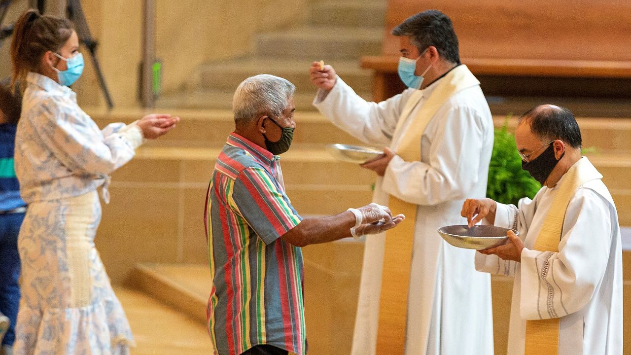 People attend a Catholic Mass during COVID-19.