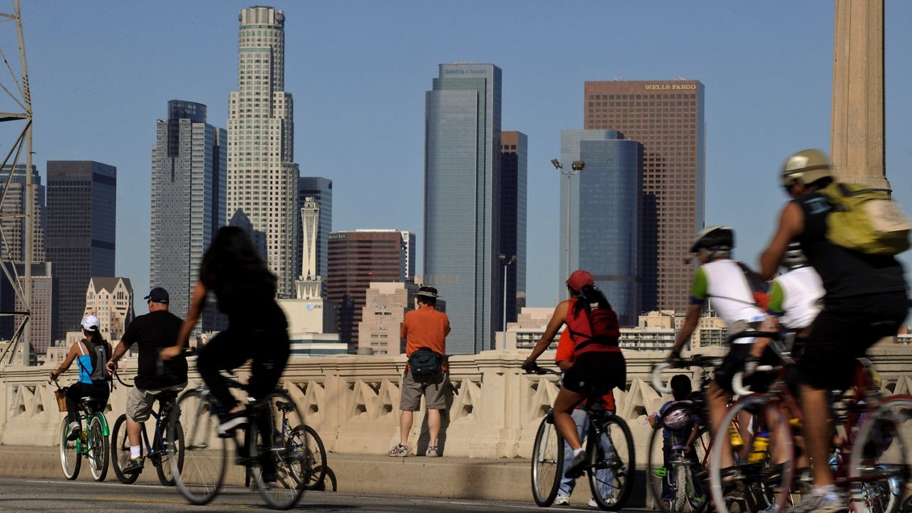 In this Oct. 9, 2011, file photo, bicyclists make their way along the Fourth Street Bridge near downtown Los Angeles as part of the CicLAvia event.  (AP Photo/Chris Carlson, File)