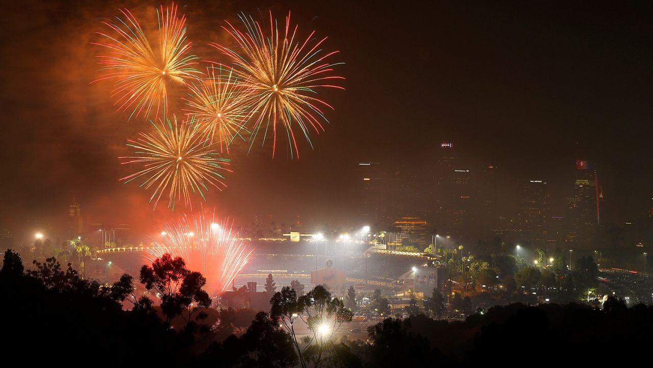 In this July 4, 2019, file photo, fireworks explode over Dodger Stadium with the Los Angeles skyline in the background following a baseball game between the Los Angeles Dodgers and the San Diego Padres in Los Angeles. (AP Photo/Mark J. Terrill, File)