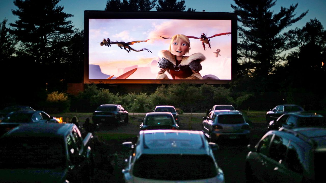 Movie-goers watch "How to Train Your Dragon 2." (AP Photo/Robert F. Bukaty, File)
