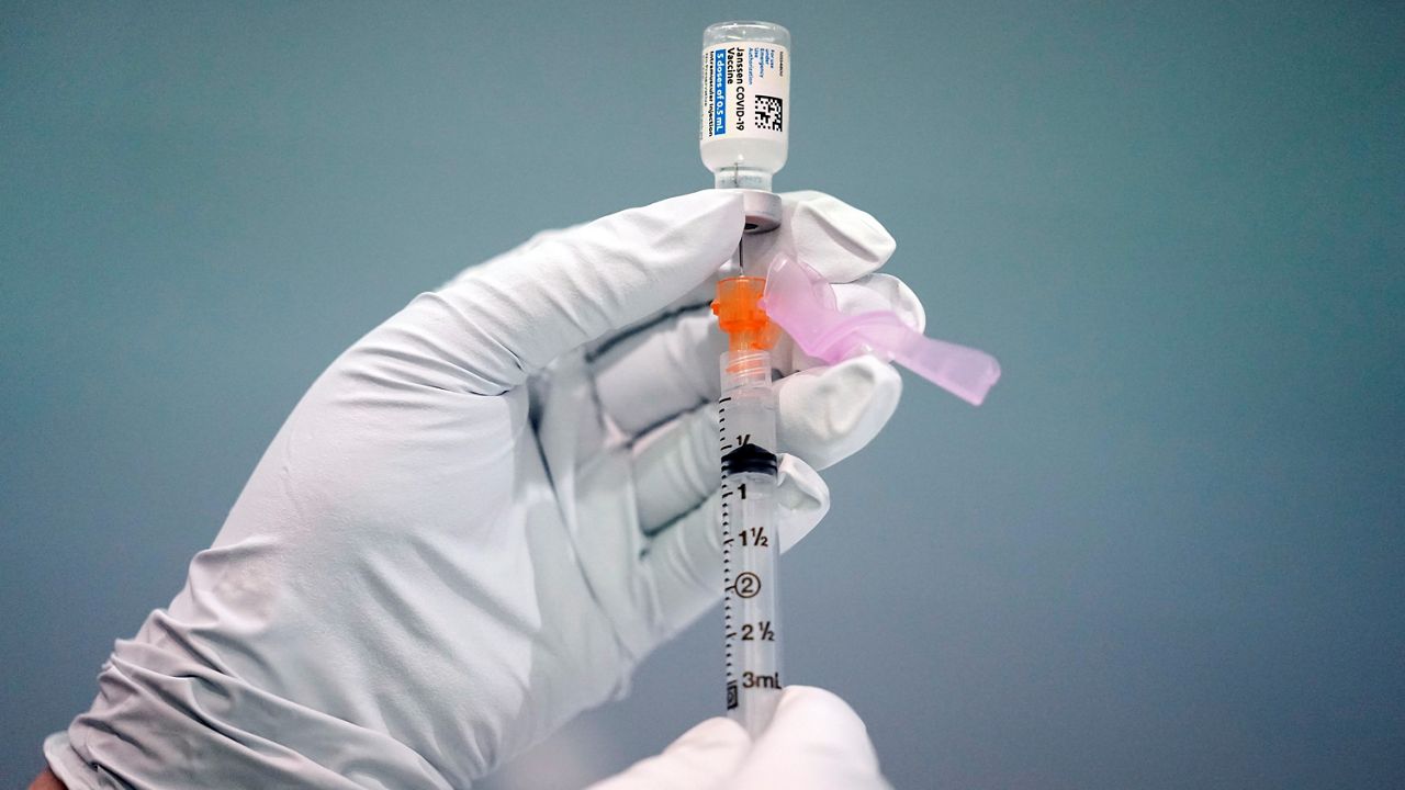 A health care worker fills a syringe with the Johnson & Johnson COVID-19 vaccine. (AP Photo, File)