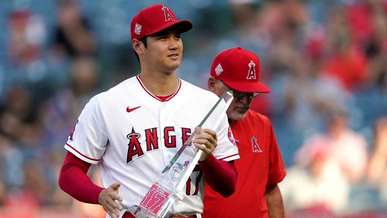 Los Angeles Angels designated hitter Shohei Ohtani holds his American League Player of the Month trophy after being presented with it Friday before a baseball game against the Seattle Mariners in Anaheim, Calif. (AP Photo/Mark J. Terrill)