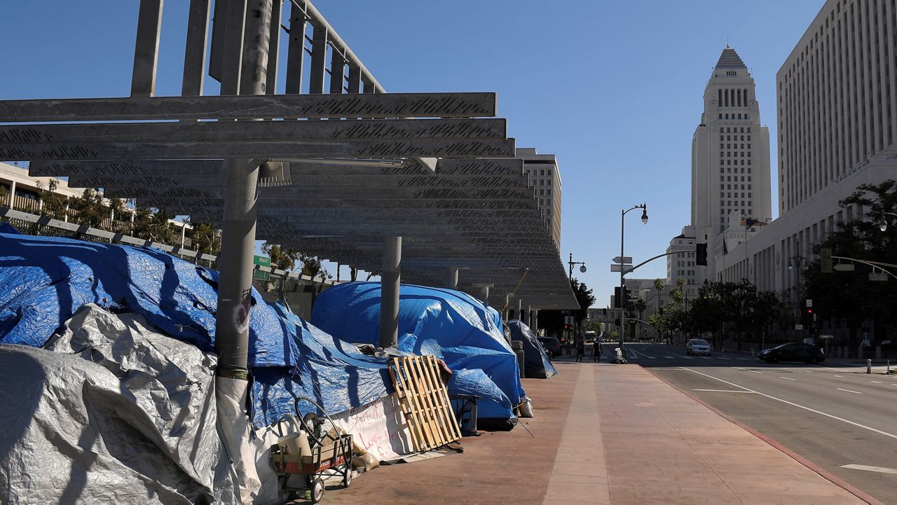 This May 21, 2020, file photo shows a homeless encampment atop the Main Street overpass of the 101 freeway during the coronavirus outbreak in downtown Los Angeles. (AP Photo/Mark J. Terrill)