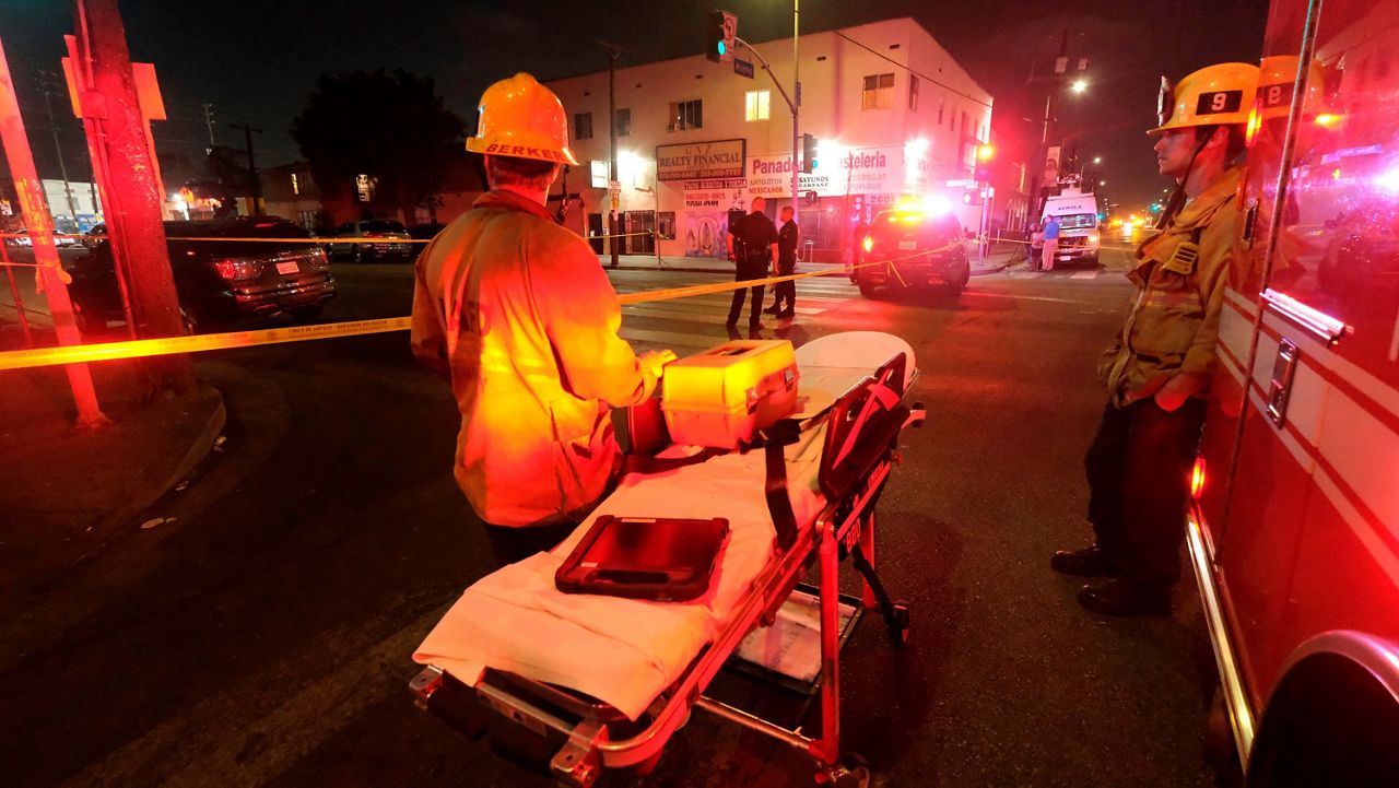 In this June 30, 2021, file photo, emergency personnel stand near the scene of a fireworks explosion in Los Angeles. (AP Photo/Ringo H.W. Chiu)