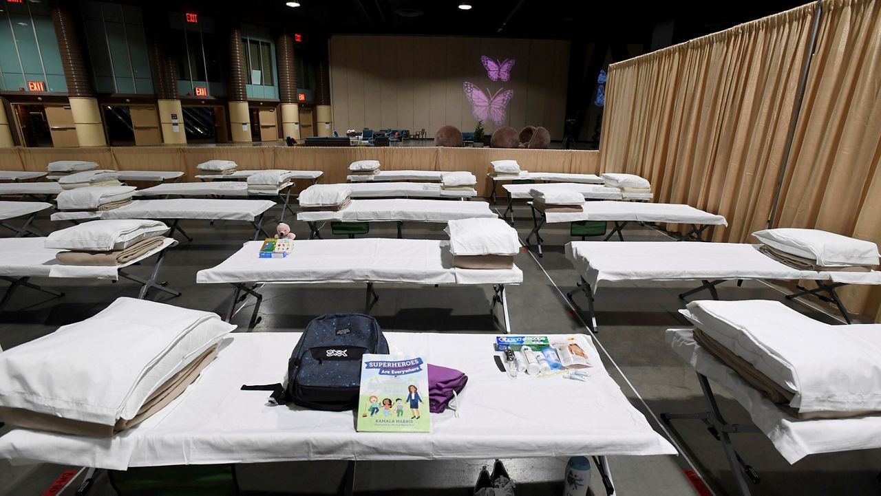 This April 22, 2021, file photo shows a sleeping area set up inside exhibit hall B of the Long Beach Convention Center in Long Beach, Calif., where migrant children found at the U.S.-Mexico border without a parent were temporarily housed. (Brittany Murray/The Orange County Register via AP)