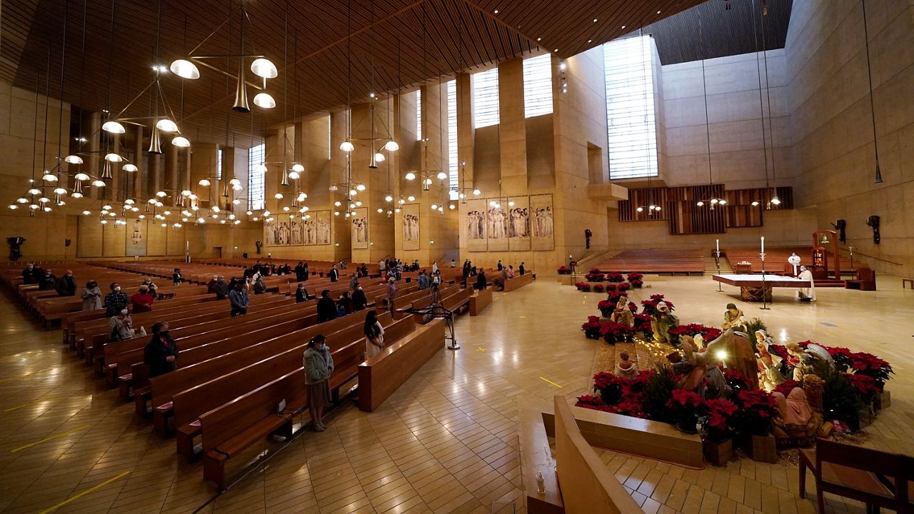 In this Dec 24, 2020, file photo, worshippers gather for Christmas Eve Mass at the Cathedral of Our Lady of the Angels in Los Angeles. (AP Photo/Ashley Landis)