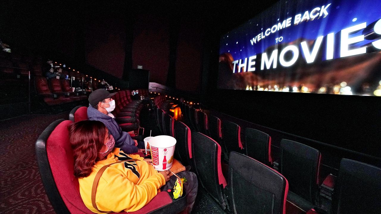 In this March 15, 2021, file photo, moviegoers wait for a film to start at the AMC 16 theater in Burbank, Calif.  (AP Photo/Mark J. Terrill)
